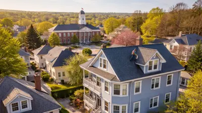 Aerial view of residential homes with asphalt shingle roofs in North Providence, Rhode Island showing classic triple-decker and Cape-style houses typical of the Town Hall neighborhood.