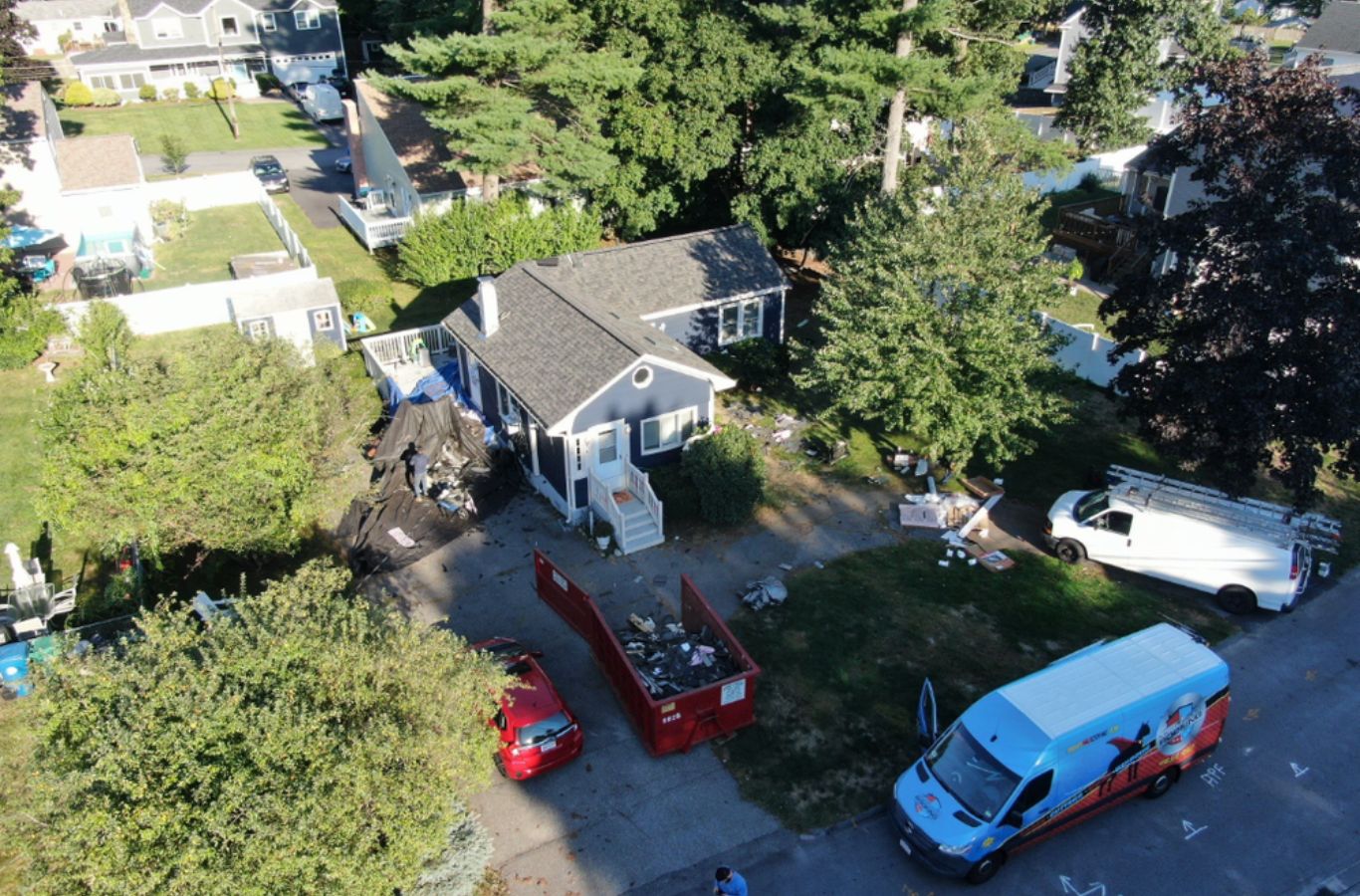 Un equipo de Mighty Dog Roofing medición y montaje de canalones sin costura en Arlington, MA para mejorar la eficiencia y evitar daños por agua.
