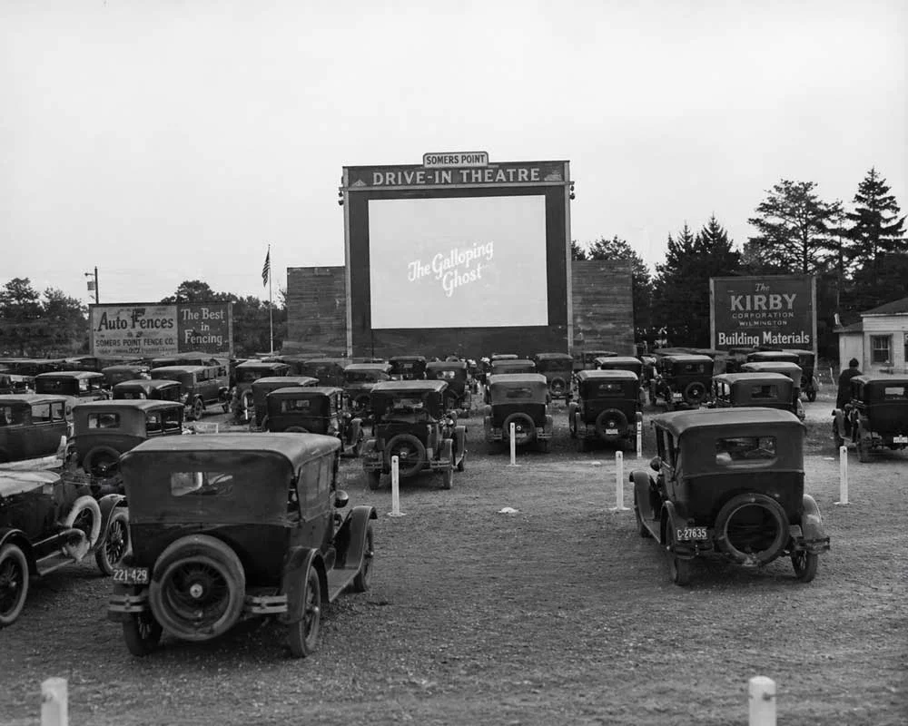 Vintage black and white photo of an early drive-in theater with classic cars in South Jersey